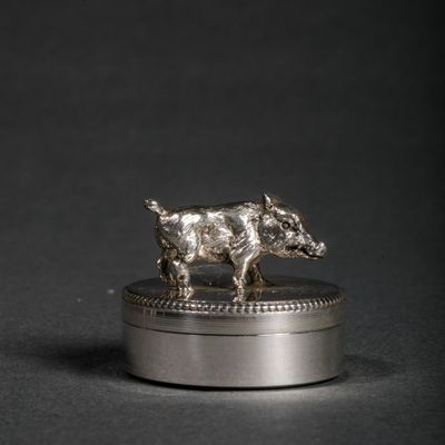 an image of a silver figurine of a boar on top of a silver box