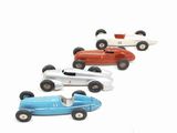 several toy cars are lined up in a row on a white surface