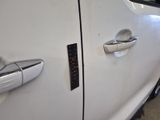 a close up of a car door handle with a sticker on it