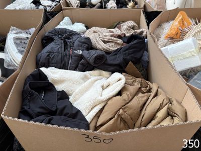 many boxes of clothes that are sitting on the floor