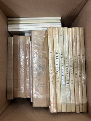 many books in a box that are sitting on a table