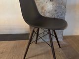 an image of a chair with a black seat on a wooden floor