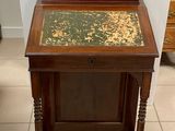a small wooden table with a green and gold top