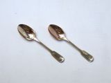 two spoons sitting next to each other on a table