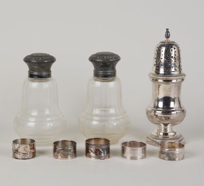 several silver and glass salt and pepper shakers and napkins