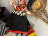 three dolls that are laying next to each other on a table