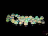white fire oplite beads on a black background
