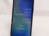 the back of a black iphone with a blue screen on a white surface