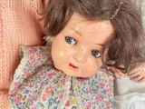 two dolls that are laying next to each other
