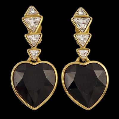 a pair of black and white diamond heart shaped earrings