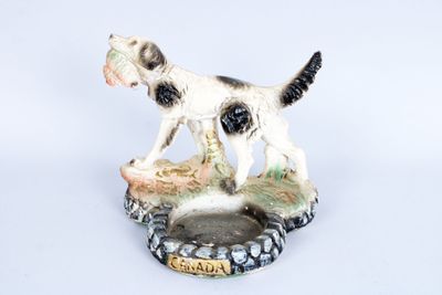 une figurine représentant un chien noir et blanc posée sur une assiette
