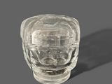 a clear glass vase with a face inside of it