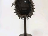 a sculpture of a man ' s face on a stand