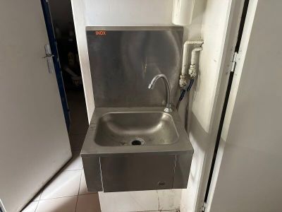 a stainless steel sink with a faucet in the corner