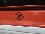 a close up of a red truck with a sticker on it ' s side