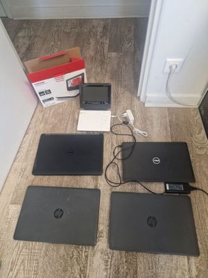 four laptops are sitting on the floor next to each other
