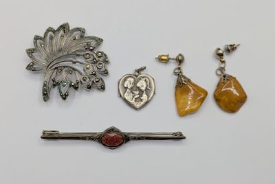 three pieces of jewelry including a broochle, a broochle, and a pin