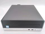 the hp desktop computer is sitting on a white surface