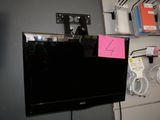 a flat screen tv hanging on a wall in a room