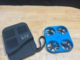 an image of a blue and black device sitting on top of a wooden table