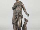 a bronze statue of a woman with a dog on a marble base