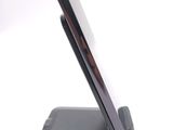a cell phone on a stand on a white surface
