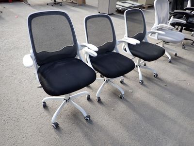four office chairs sitting in a row on the floor