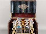 a small wooden box with a glass set inside of it