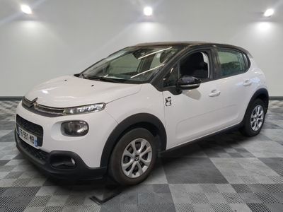 the white citrole is parked on a checkered tile floor