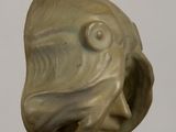 a sculpture of a fish head on a black stand