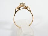 a close up of a gold ring with two diamonds on it