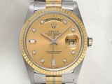 a gold and silver rolex watch with diamonds on the dial