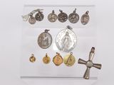 a glass display case with a cross, medal, and other religious items