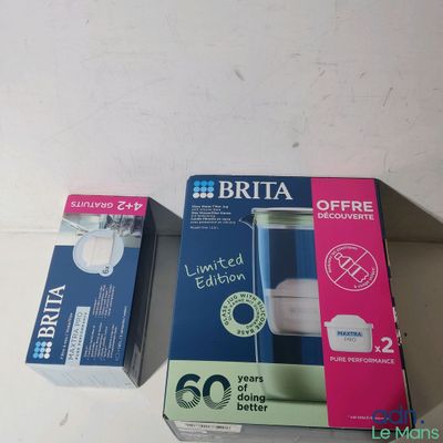 two boxes of toothpaste sitting on a table next to each other