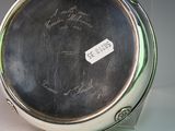 a silver plate with writing on it sitting on a table