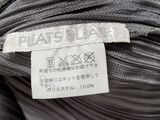 the label on the top of a gray shirt is clearly visible