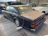 a car that is parked in a garage with other cars