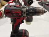 a close up of a corded drill on a table in a warehouse