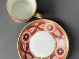 a close up of a cup and saucer on a table