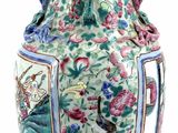 a vase with a floral design on it sitting on a table