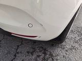 a close up of a white car with black rims
