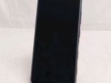 the back of a black cell phone sitting on top of a white table