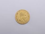 a close up of a gold coin on a white surface