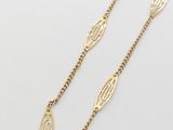 a gold necklace with a chain that has a small initial on it