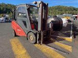 un chariot élévateur rouge garé sur un parking