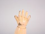 a wooden hand that is holding something in it ' s palm