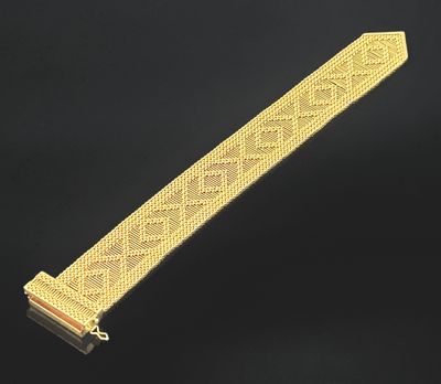 a gold bracelet with a diamond design on it