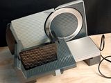 a silver and black toaster sitting on top of a wooden table