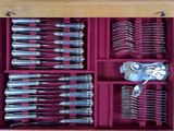many forks and spoons in a wooden box