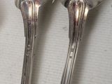 three spoons that are sitting next to each other on a table